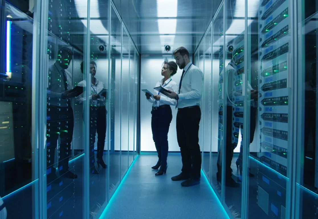 a man and woman standing in a room with glass walls a man and woman standing in a room with glass walls