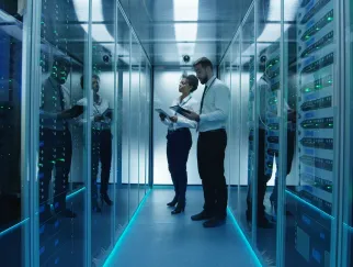 a man and woman standing in a room with glass walls