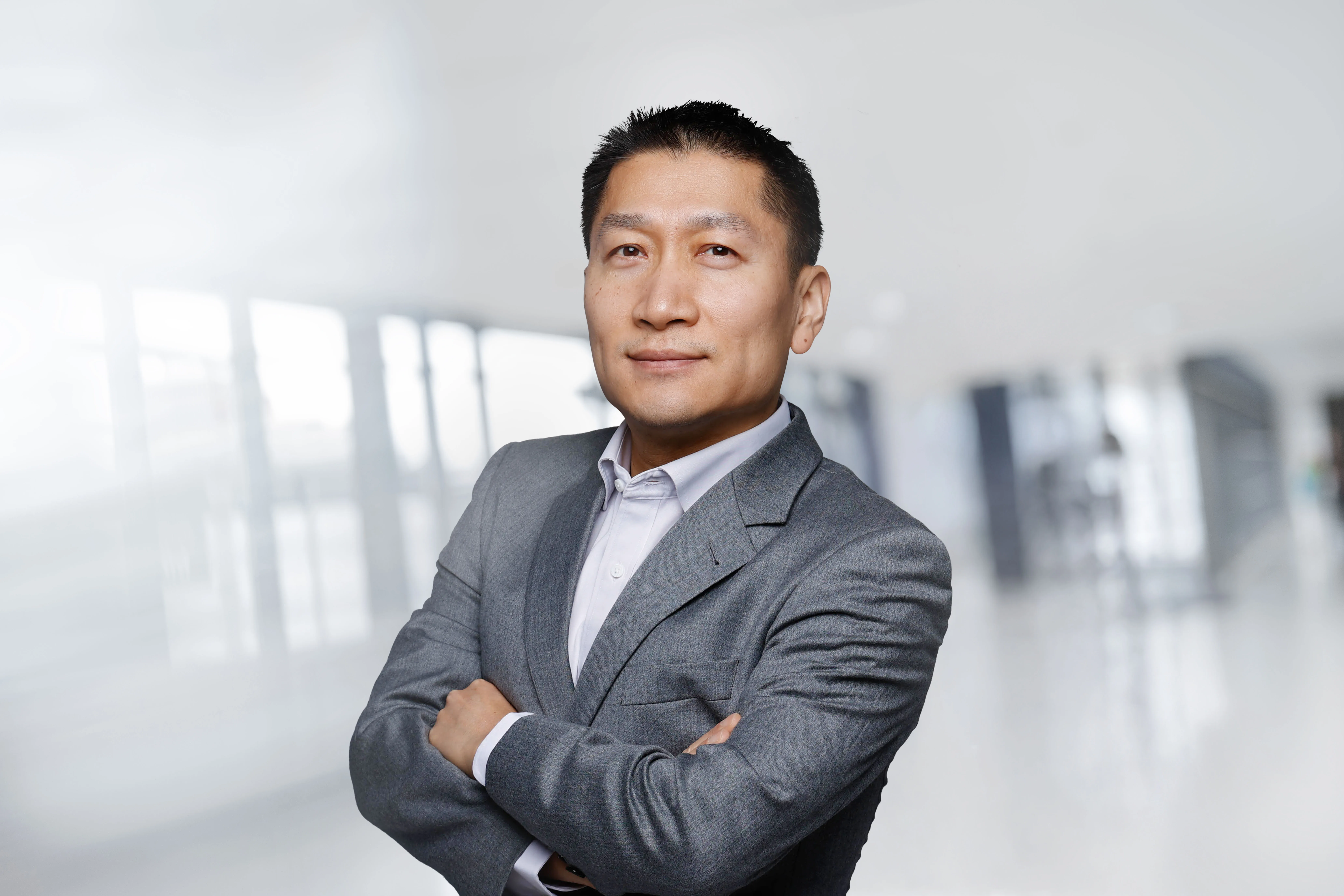 a man in a suit with his arms crossed