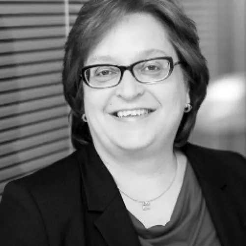 Eine Frau mit Brille und schwarzer Jacke