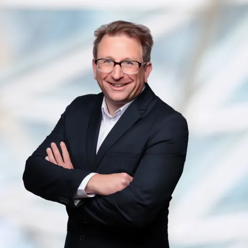 a man in a suit with his arms crossed