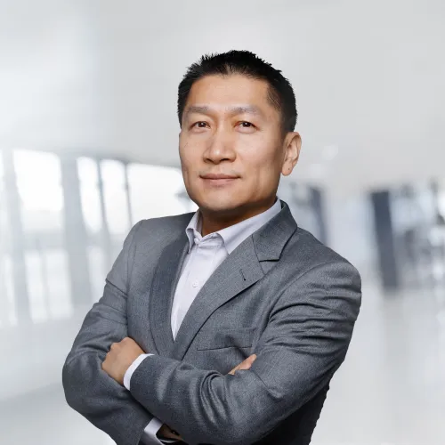a man in a suit with his arms crossed